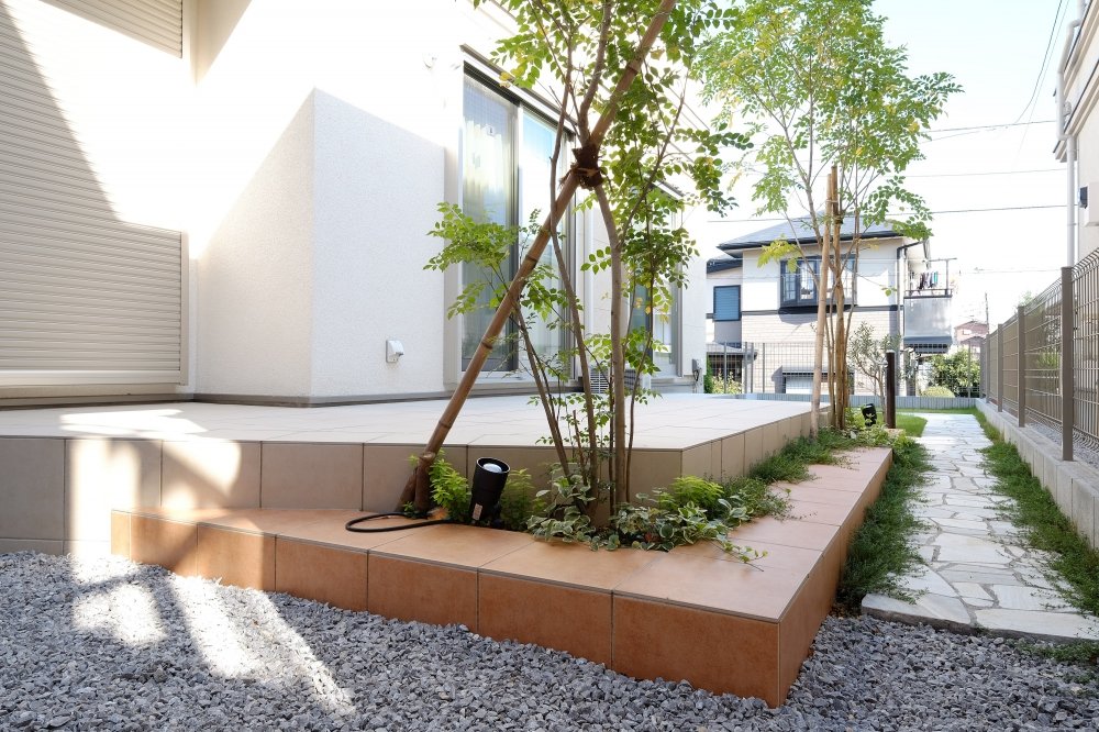 Tile Terrace and Lawn Space Divided with Garden Path