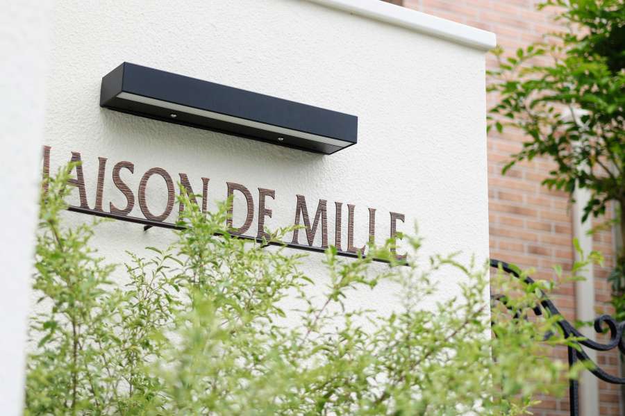 白い壁と鋳物のネームプレート