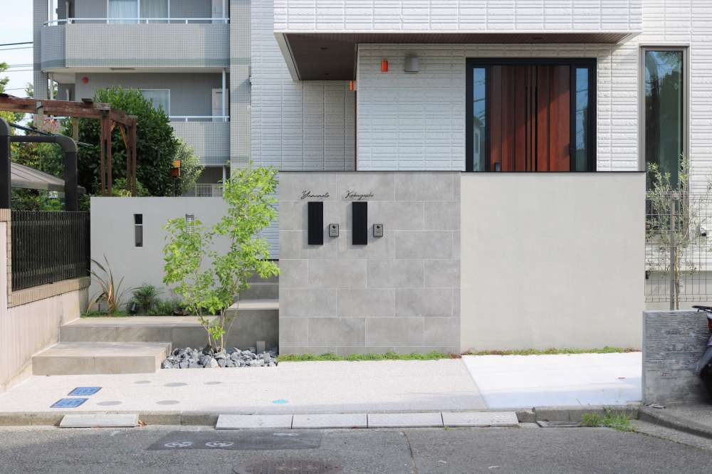 タイル張りの門柱とジョリパット塗装の袖壁